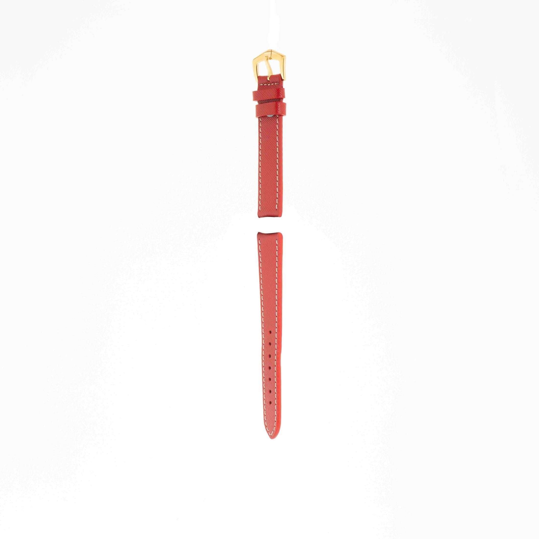 Angled view of Red Hammered Calfskin strap with ecru stitching and gold buckle, highlighting its slim profile and craftsmanship.